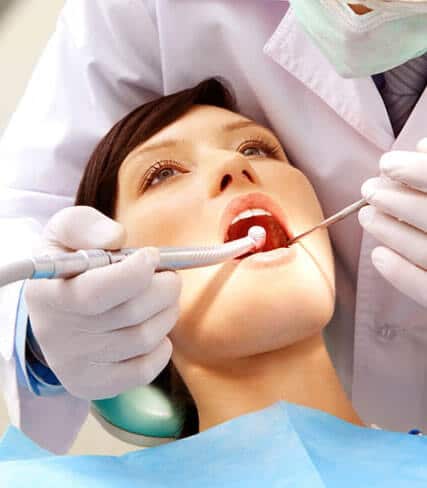 Dentist examining patient's teeth during oral checkup in dental office